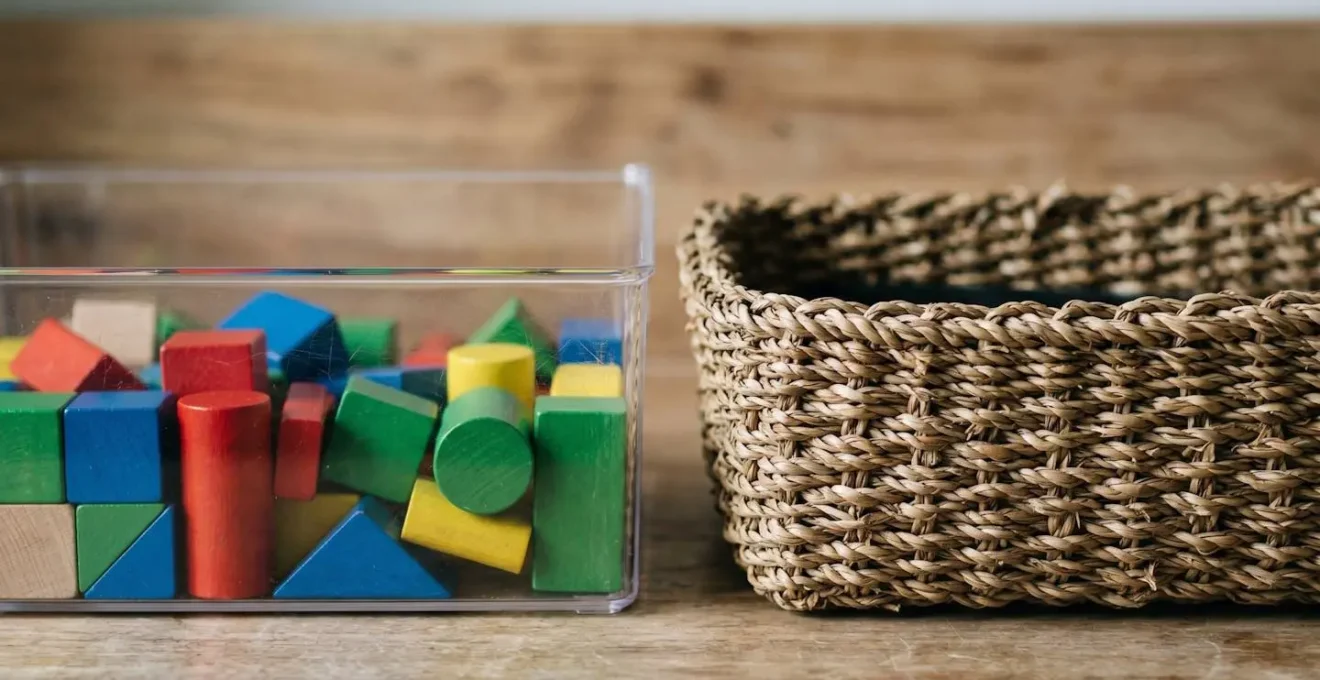 Close-up comparison of transparent storage container and natural woven basket side-by-side showing visibility contrast for toy organization